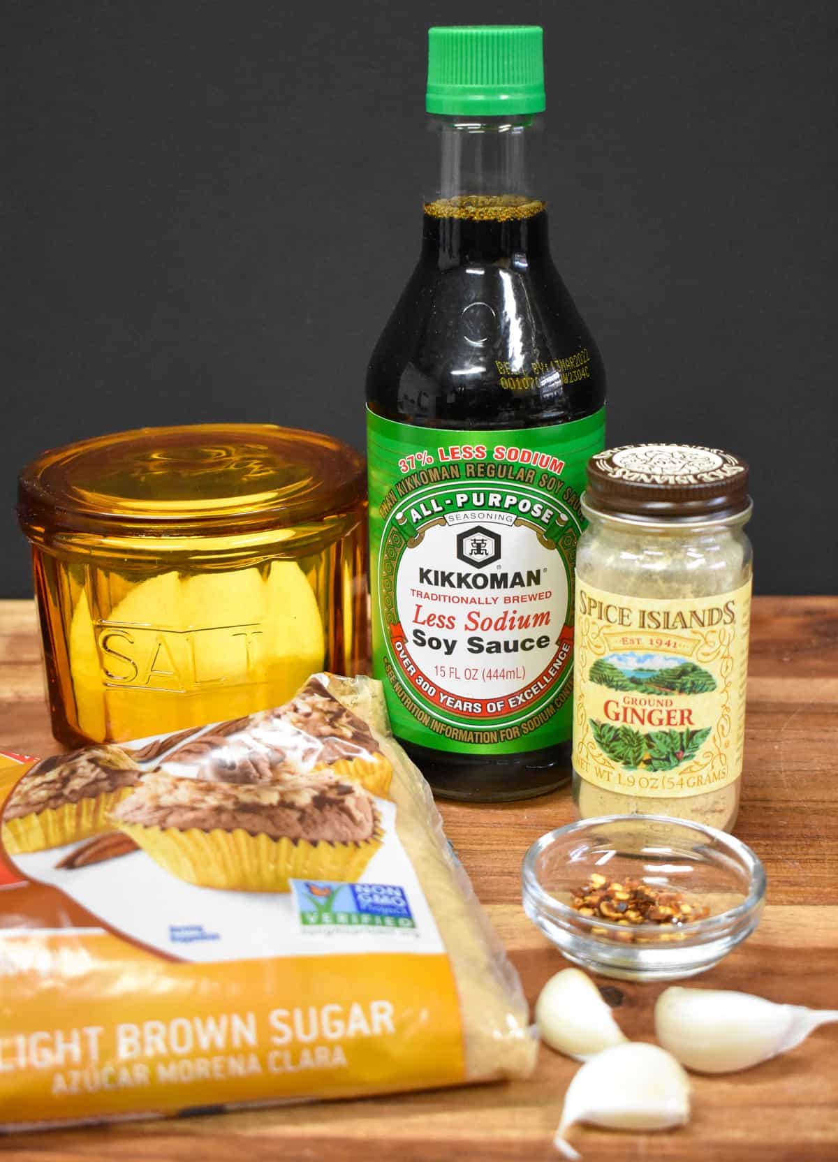 The ingredients for the Asian marinade displayed on a wood cutting board.