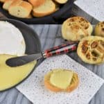 Baked Brie and Roasted Garlic served on a gray board