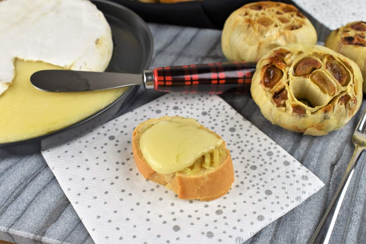 Baked Brie and Roasted Garlic served on a toasted baguette round