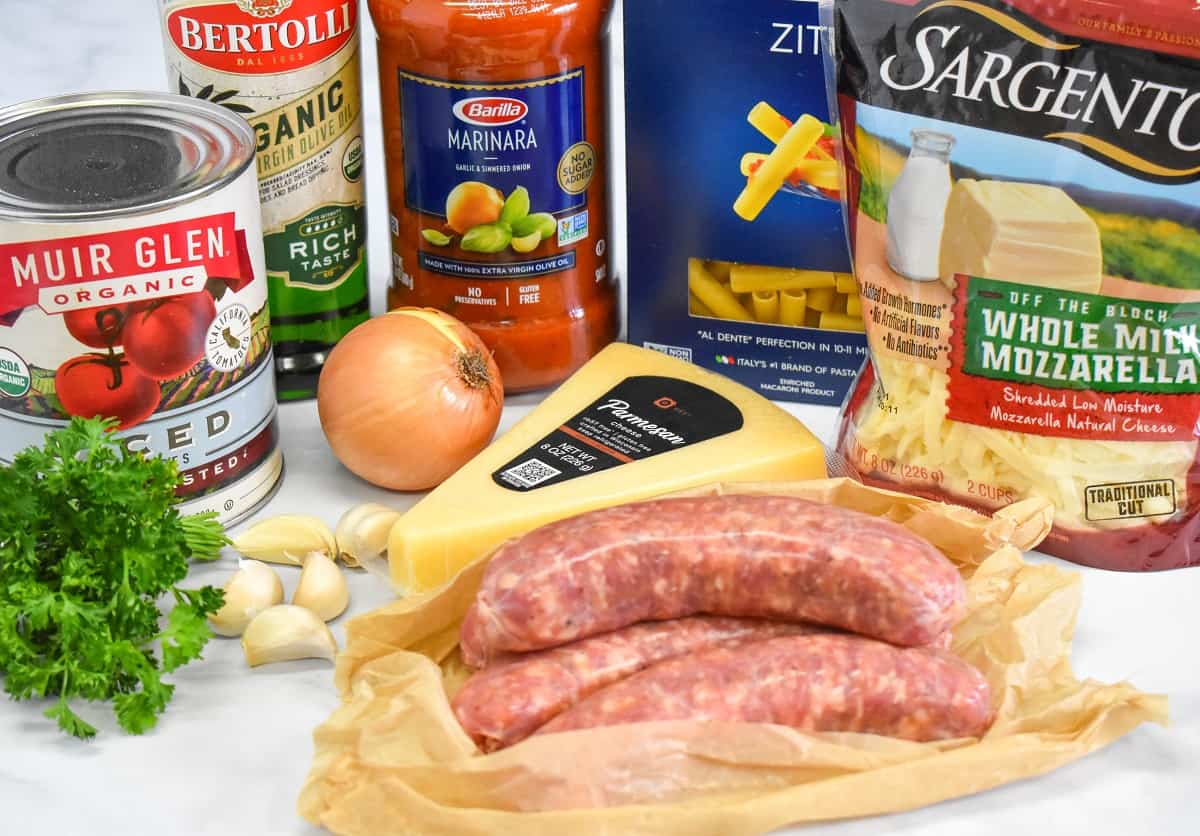 The ingredients for the baked ziti arranged on a white table.