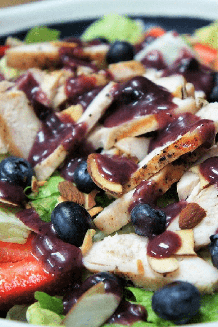 This berry chicken salad is so good you won’t mind having a salad for dinner. Simply-seasoned grilled chicken, strawberries, blueberries and toasted almonds all sitting on top of a bed of crisp lettuce. #berrychickensalad #blueberries #salad #summersalads #summertimerecipes