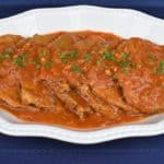 Bistec en Cazuela, thin steaks with a tomato sauce served in a white platter