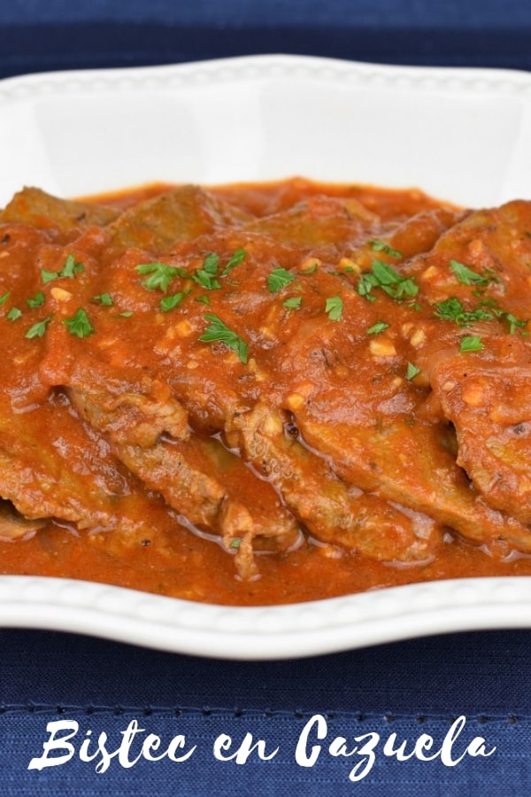 Bistec en cazuela translates to steak in a pot, and that’s what it is, kind of. It's thin steaks cooked in a flavorful tomato sauce with garlic and plenty of sliced onions. It's a popular Cuban recipe and really easy to make. Serve it with white rice for a filling, affordable meal, that's also delicious! #bistecencazuela #Cubanfood #cubanrecipes #beef #steakintomatosauce #steak #easyrecipes