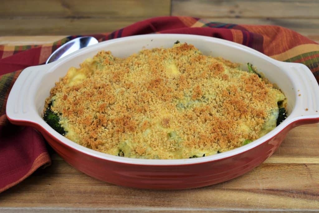 Baked Broccoli Cheese Casserole with a golden topping and served in a red dish
