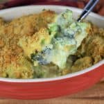 A spoonful of Broccoli Cheese Casserole showing the broccoli, cheese sauce and the crunchy breadcrumbs