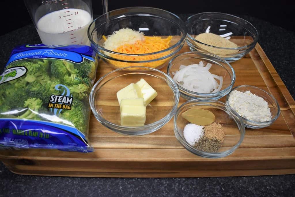 Broccoli Cheese Casserole Ingredients arranged on a wood cutting board