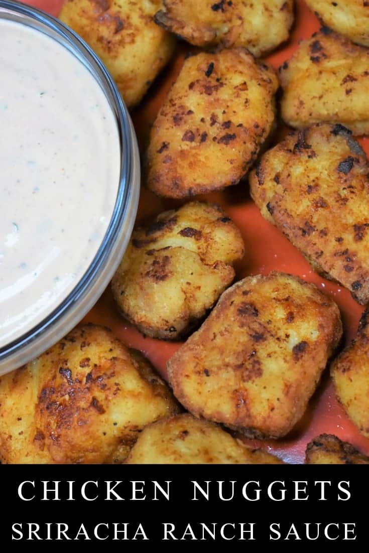 These chicken nuggets are served with an easy to make sriracha ranch dipping sauce. They’re great for the weekend served with some ice cold beverages, or for your next game-day spread. If you have any Sriracha junkies in your house, like I do, this is the perfect dish. #chickennuggets #sriracharanchsauce #sriracharanch