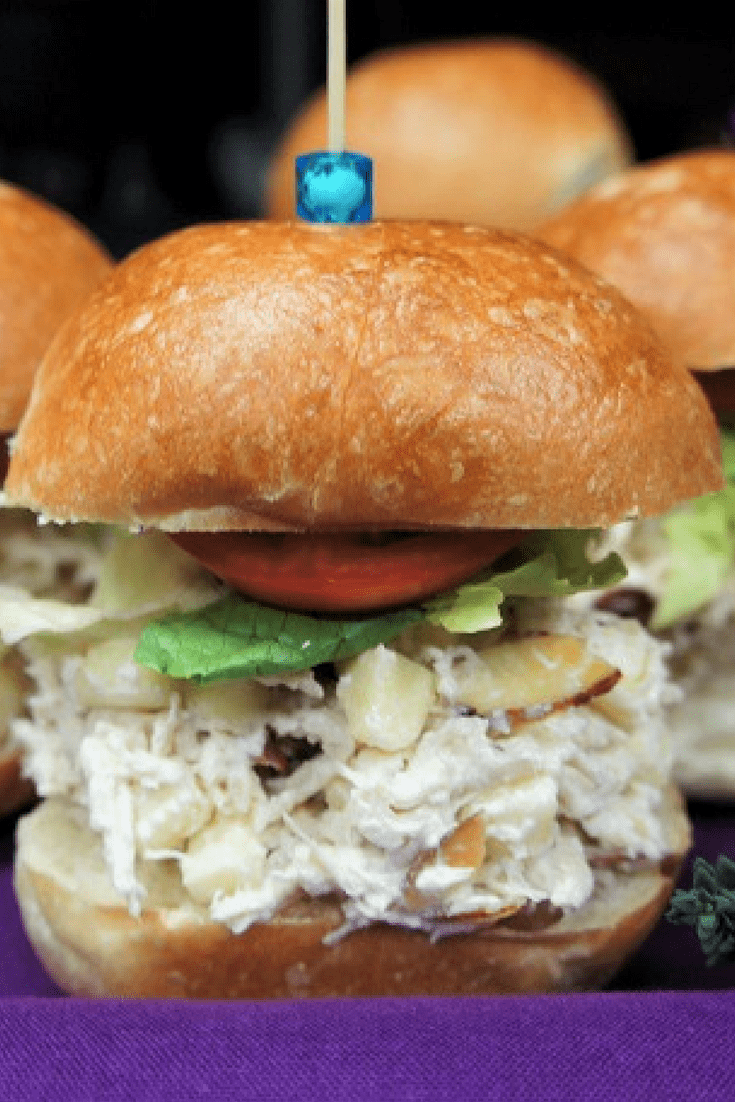 This chicken salad is quick and easy to make, perfect for busy weeknights, lunch prep or a last minute party snack. Here we pile the chicken salad on small dinner rolls and top with lettuce and tomatoes to make pretty party chicken salad sandwiches. #chickensalad #chicken #partyfood #sandwiches