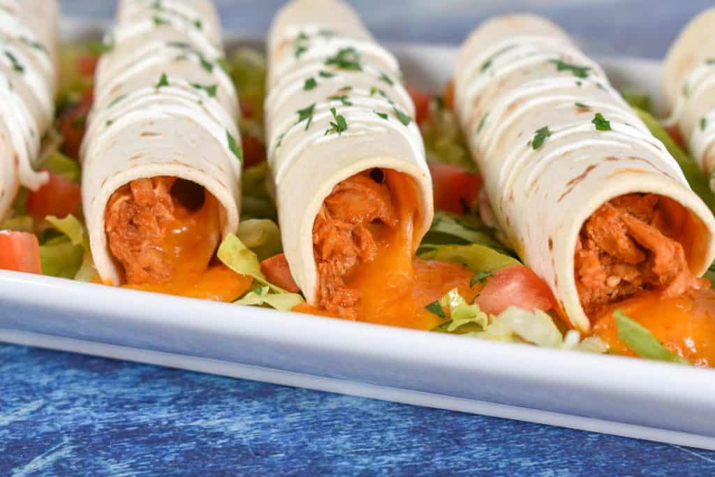A close up of the taquitos from the front showing the chicken and cheese.
