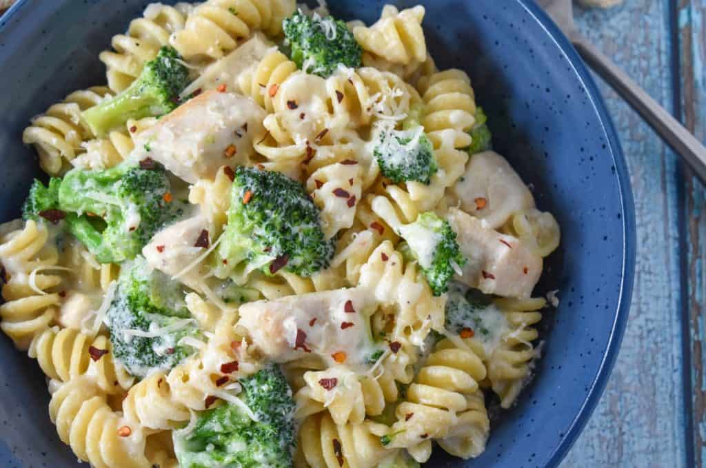 A close-up of the pasta served in a blue bowl.