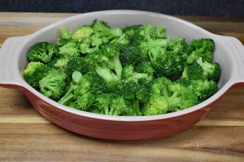 Cooked Broccoli in a red casserole dish