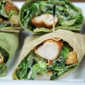 Crispy Chicken Caesar Salad Wraps chopped breaded chicken combined with Caesar salad rolled in thin wraps, cut in half and secured with toothpicks