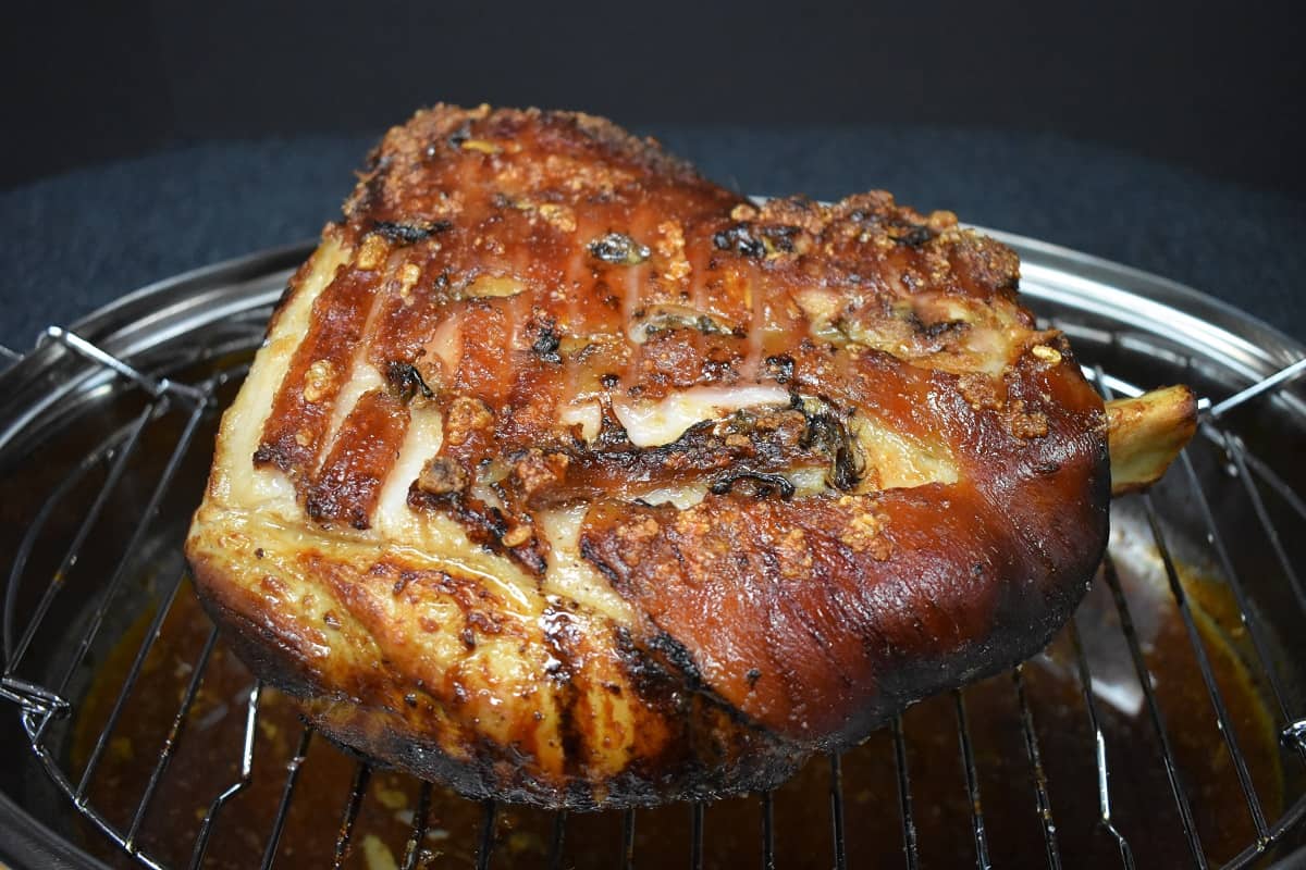 A roasted pork shoulder on a baking racking rack.