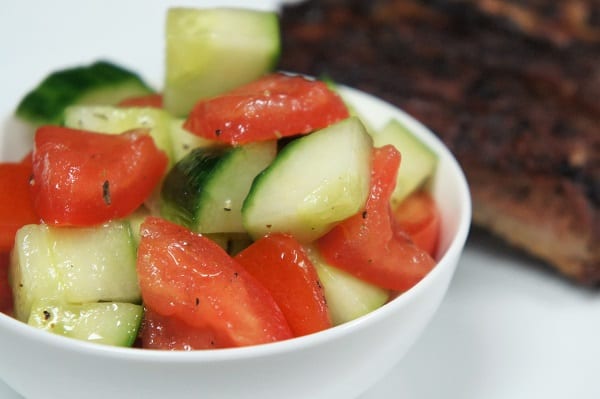 Simply refreshing is the perfect way to describe this cucumber tomato salad. Just a few ingredients come together beautifully to make the perfect side dish for summer. #cucumbertomatosalad #summersides #tomatoes #cucumbers #easysides #sidedishes