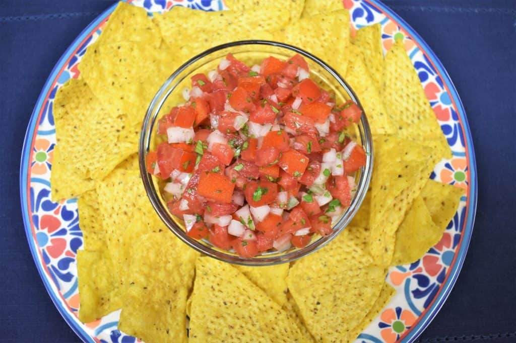 Fresh Salsa served in a clear bowl with corn tortilla chips.