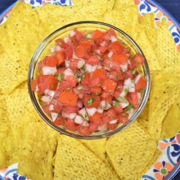 Fresh Salsa served in a clear bowl with corn tortilla chips.