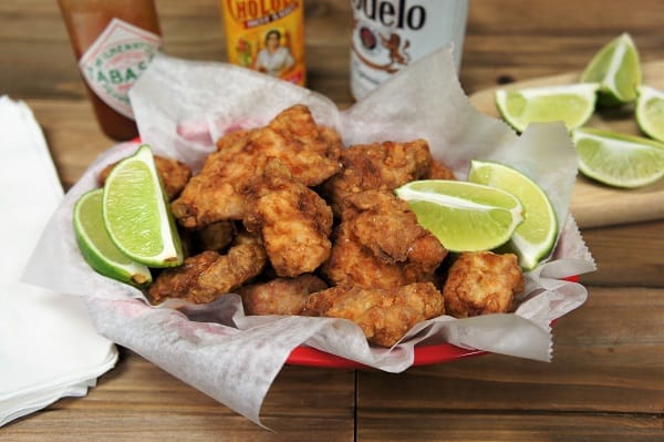 Fried Pork Chunks, served in a basket with lots of lime wedges and hot sauce