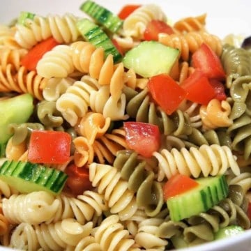 Garden Pasta Salad colorful rotini pasta with diced tomatoes and cucumbers served in a large white bowl