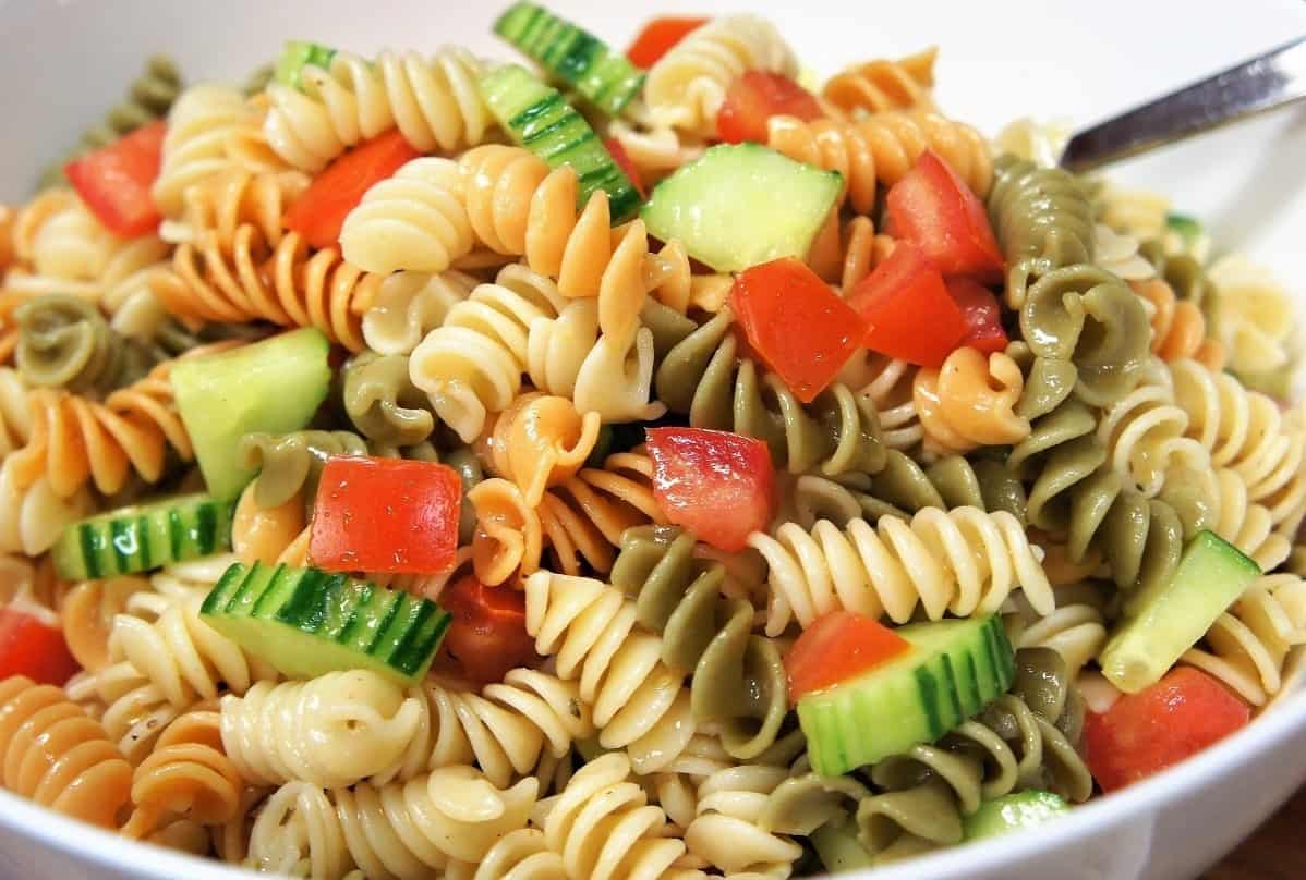 Garden Pasta Salad colorful rotini pasta with diced tomatoes and cucumbers served in a large white bowl