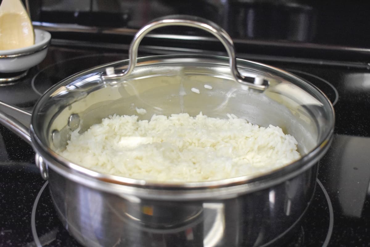 The sauce pan on the stove with a glass top.