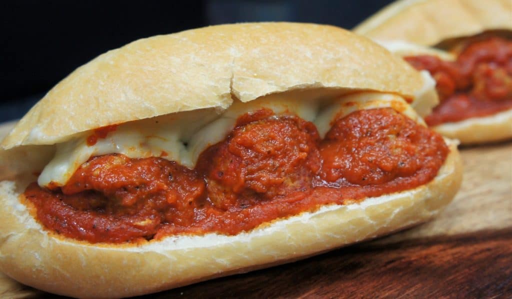 Italian Sausage Meatball Subs three saucy Italian sausage meatballs on a hoagie bun with melted mozzarella cheese