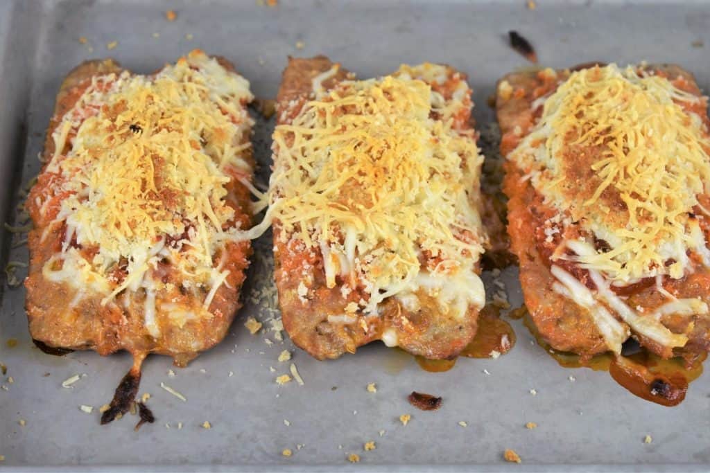 Italian Sausage Parmigiana on a metal baking sheet and baked