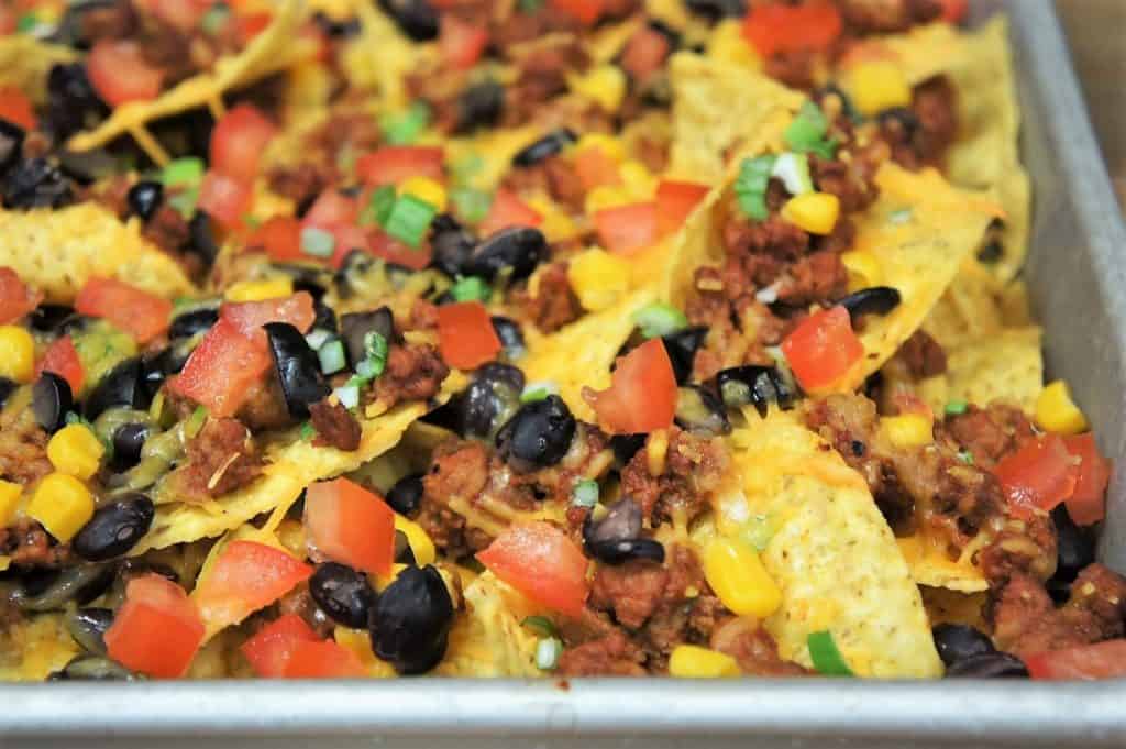 A close up image of loaded nachos.