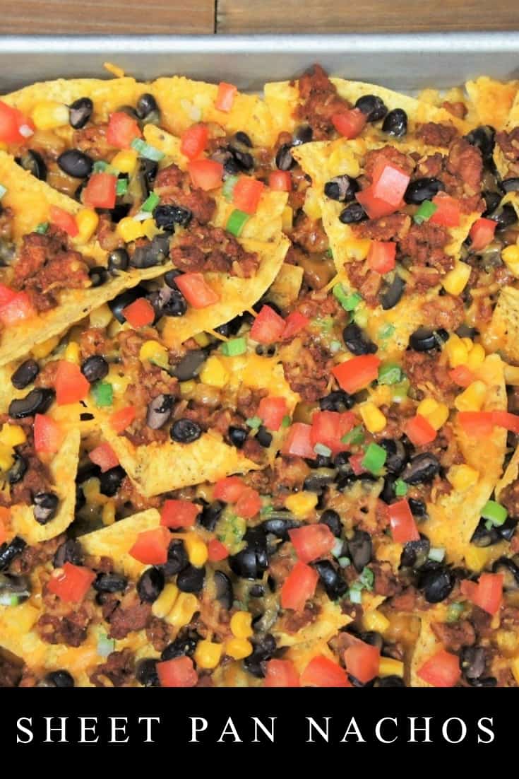 These loaded sheet pan nachos are easy to make and absolutely delicious. Corn tortilla chips are loaded up with flavorful turkey taco meat, black beans, corn, black olives, green onions, tomatoes, and of course, cheese. #loadedsheetpannachos #sheetpannachos #nachos #loadednachos #gamedayappetizers #appetizers #partyfood