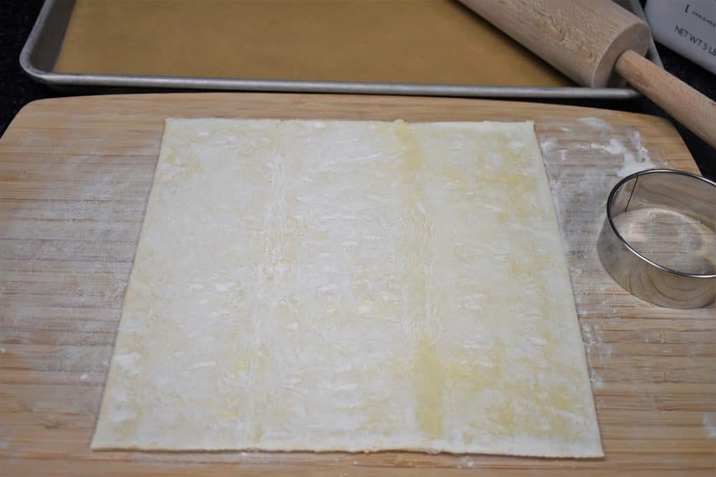 A sheet of puff pastry a lightly floured cutting board