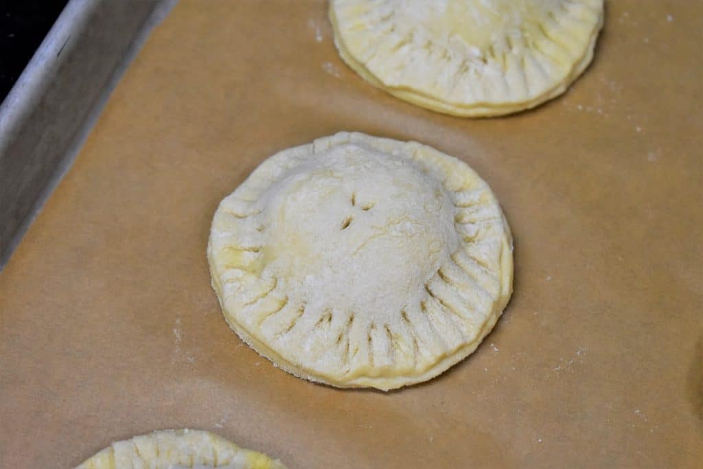 Unbaked Pastelitos on a Baking Sheet lined with parchment paper