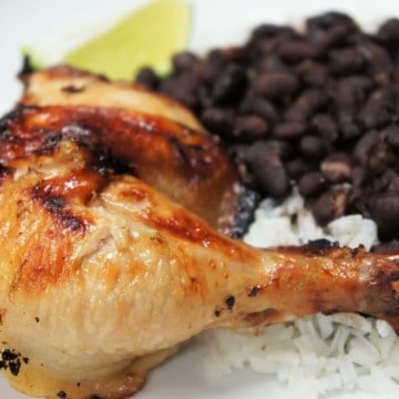 Mojo Marinated Grilled Chicken leg and thigh served with rice and black beans