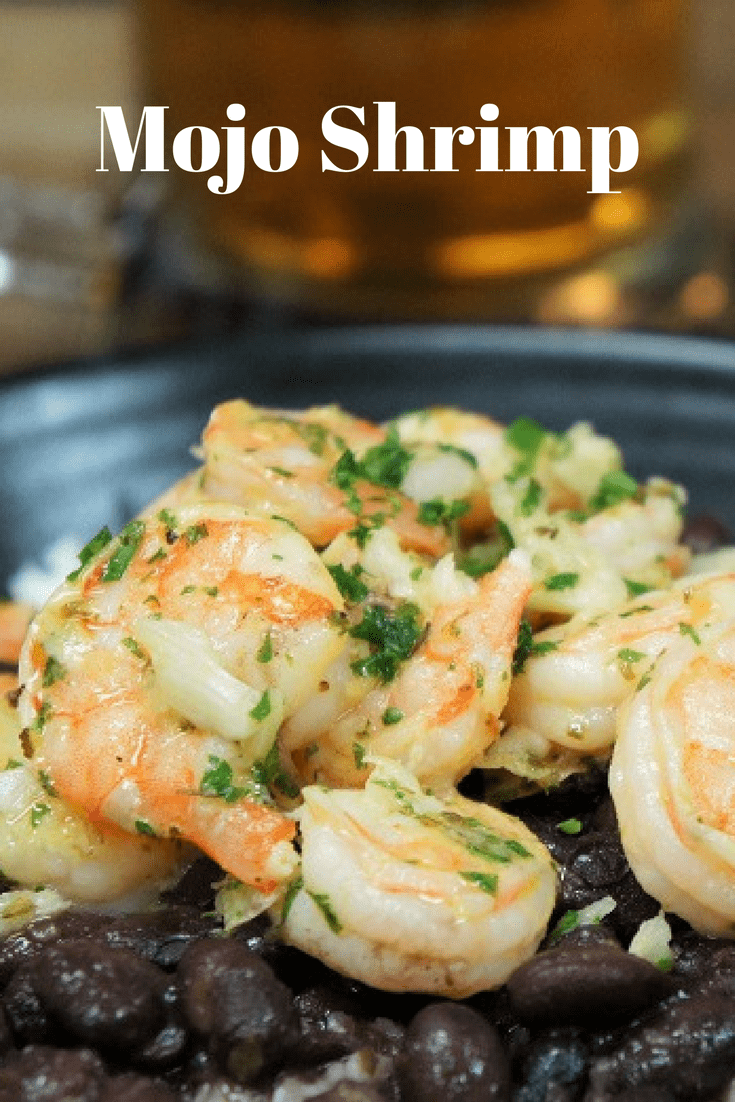 This Mojo Shrimp is a simple and tasty dish that will add a tropical flair to your weeknight meal. In this recipe, shrimp is marinated and cooked in a homemade Cuban style mojo and served with white rice and black beans. This meal is easy, filling and delicious, just what we all need for busy nights. #mojoshrimp #shrimp #mojo #Cubanfood #easydinners