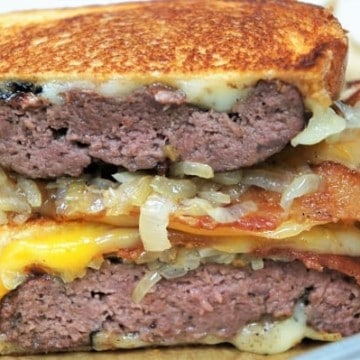 Patty Melts cut in half, stacked with grilled onions and melted cheese