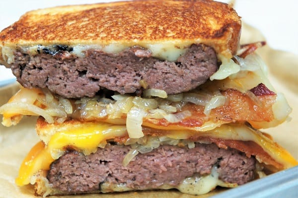 Patty Melts cut in half, stacked with grilled onions and melted cheese