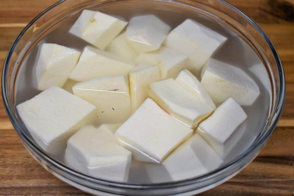 Peeled Cubed Malanga in a bowl covered with water