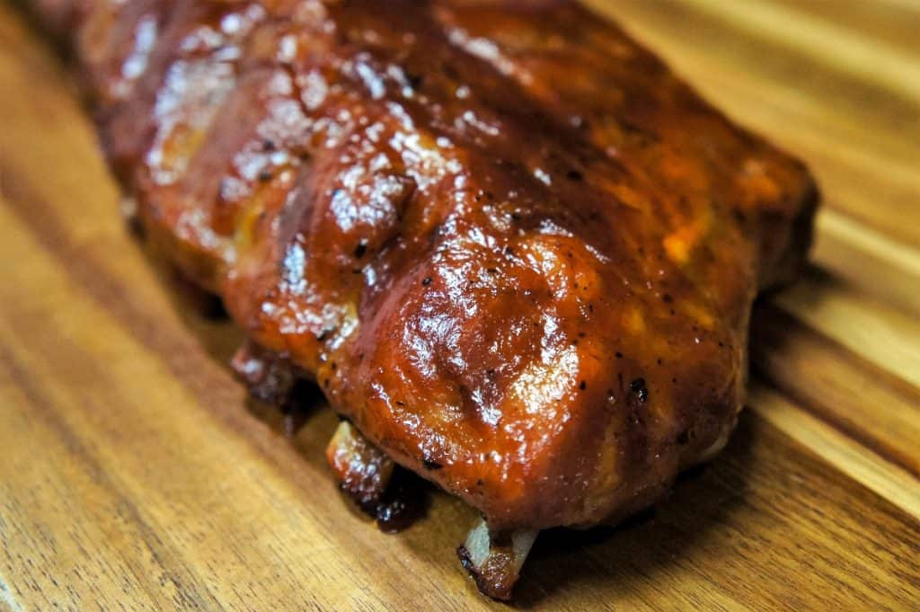 Pineapple habanero ribs on a wood cutting board.