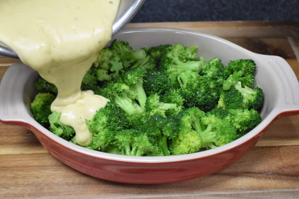 Pouring Cheese Sauce Over Broccoli