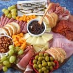 The ingredients arranged on a large wood cutting board and displayed on a blue table.