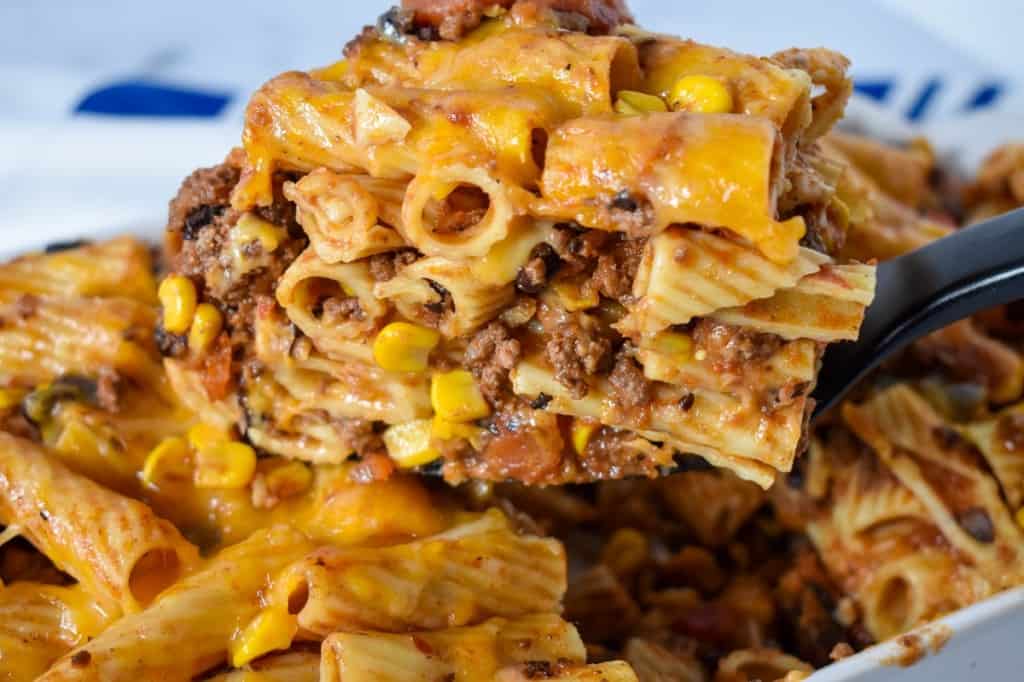 A close up image of a cut piece of the southwest pasta held up by a spatula.