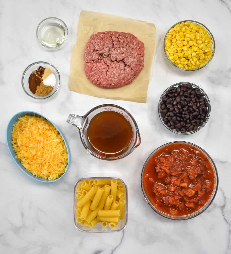 The prepped ingredients for the pasta arranged on a white table.