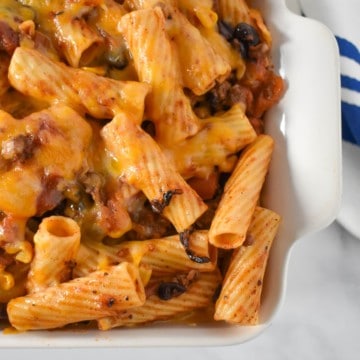 A close up image of the southwestern pasta in a white casserole dish.
