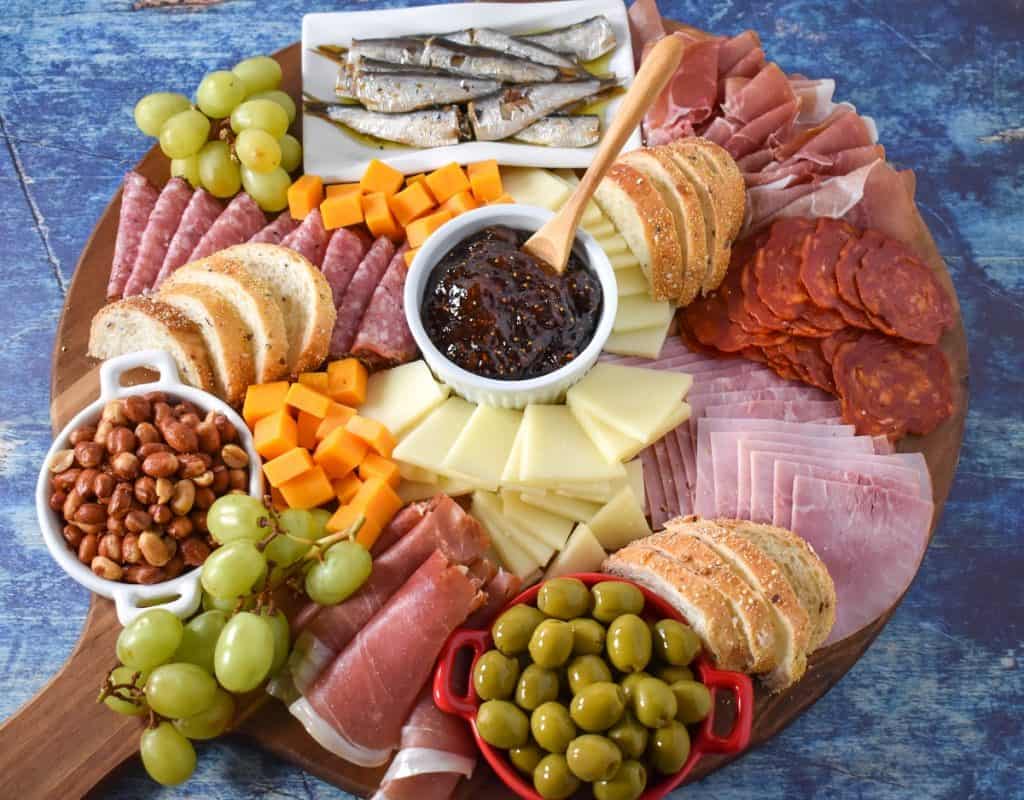 The ingredients arranged on a large wood cutting board and displayed on a blue table.
