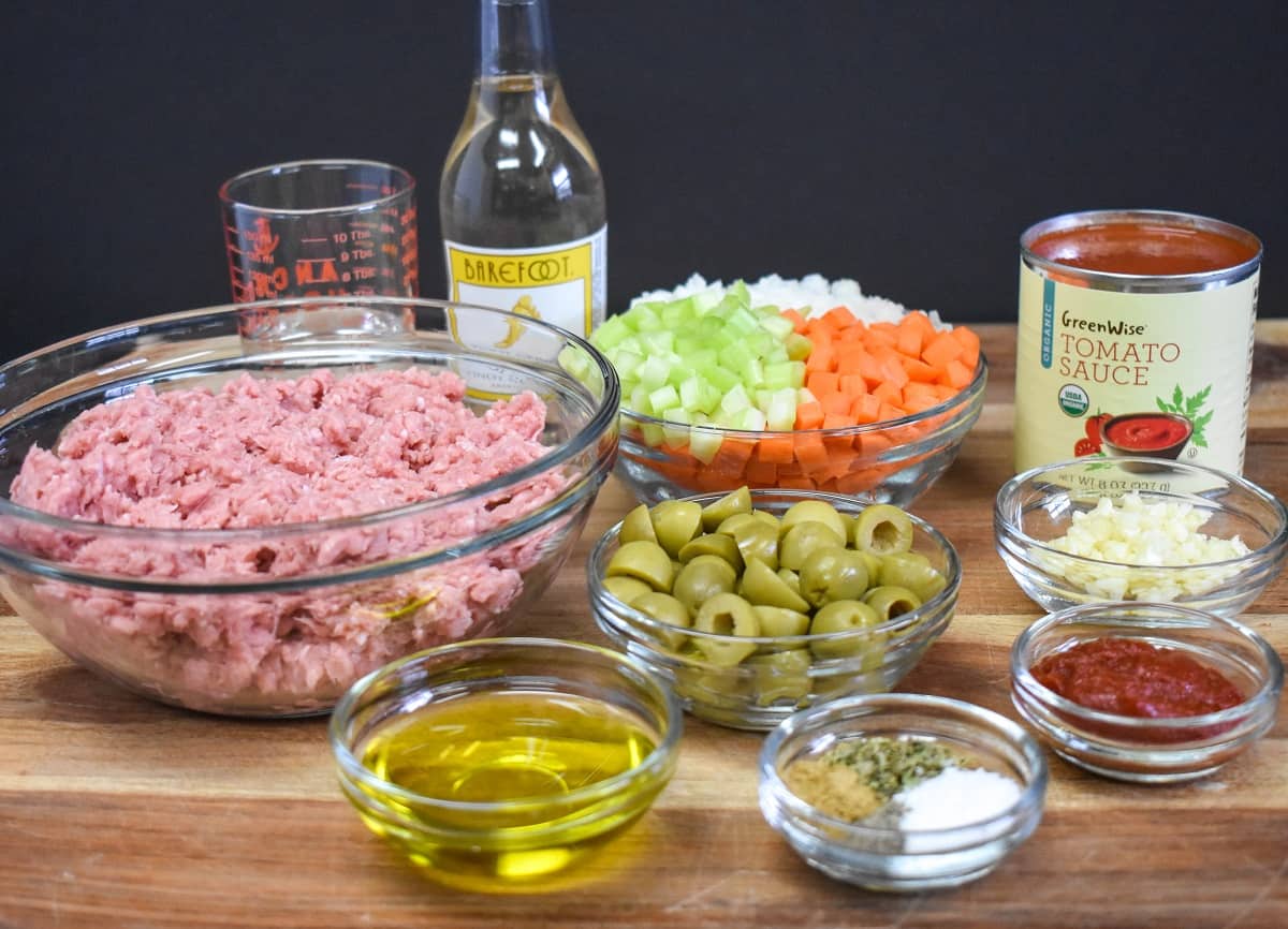 The ingredients for turkey picadillo, prepped and separated in glass bowls.