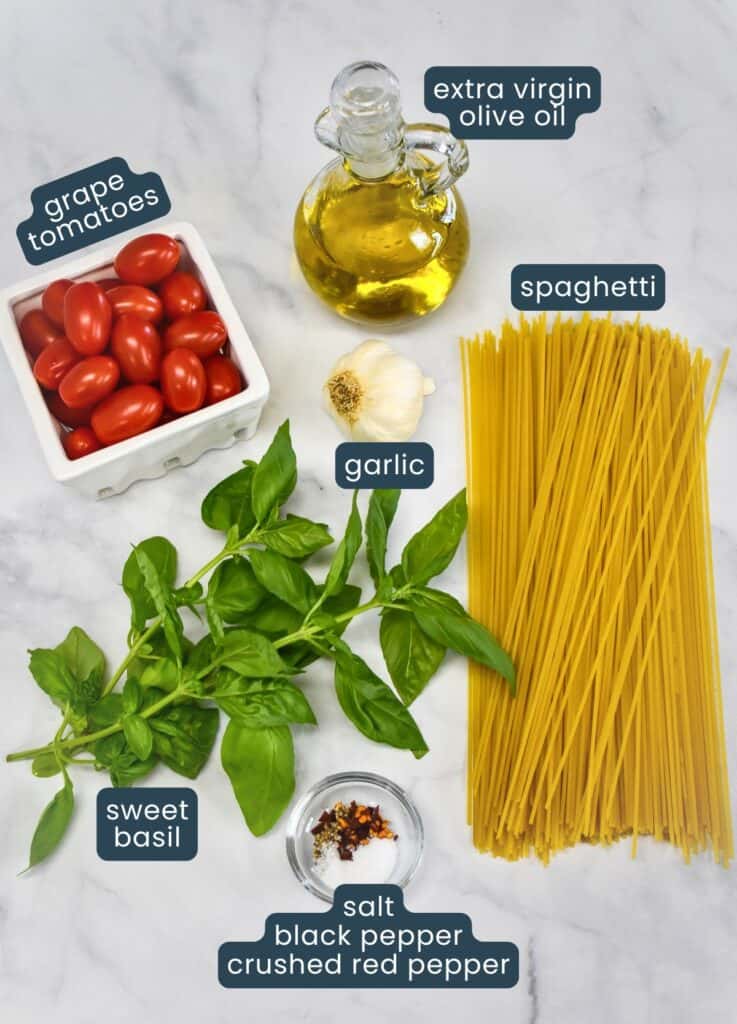 The ingredients for the dish arranged on a white table with each labeled.