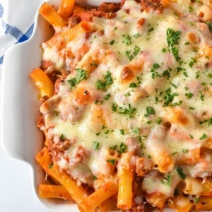 The finished baked ziti in a white casserole dish.