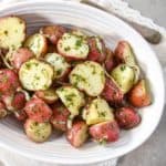 The chimichurri potatoes served in a white bowl.