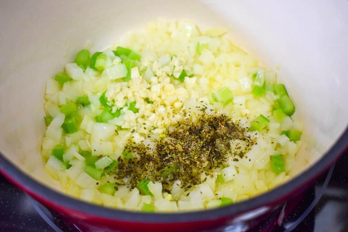 Garlic, oregano, and black pepper added to the sautéed onion and celery.