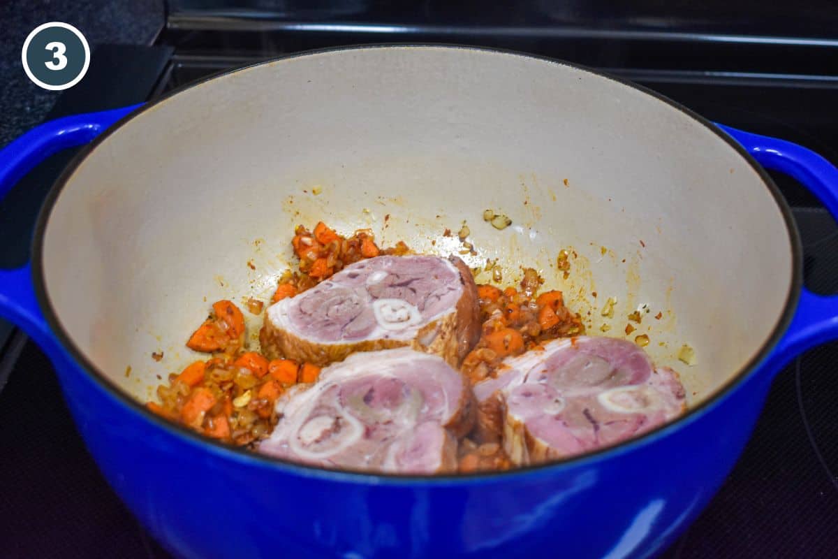 Smoked ham shanks added to the seasoned vegetables.