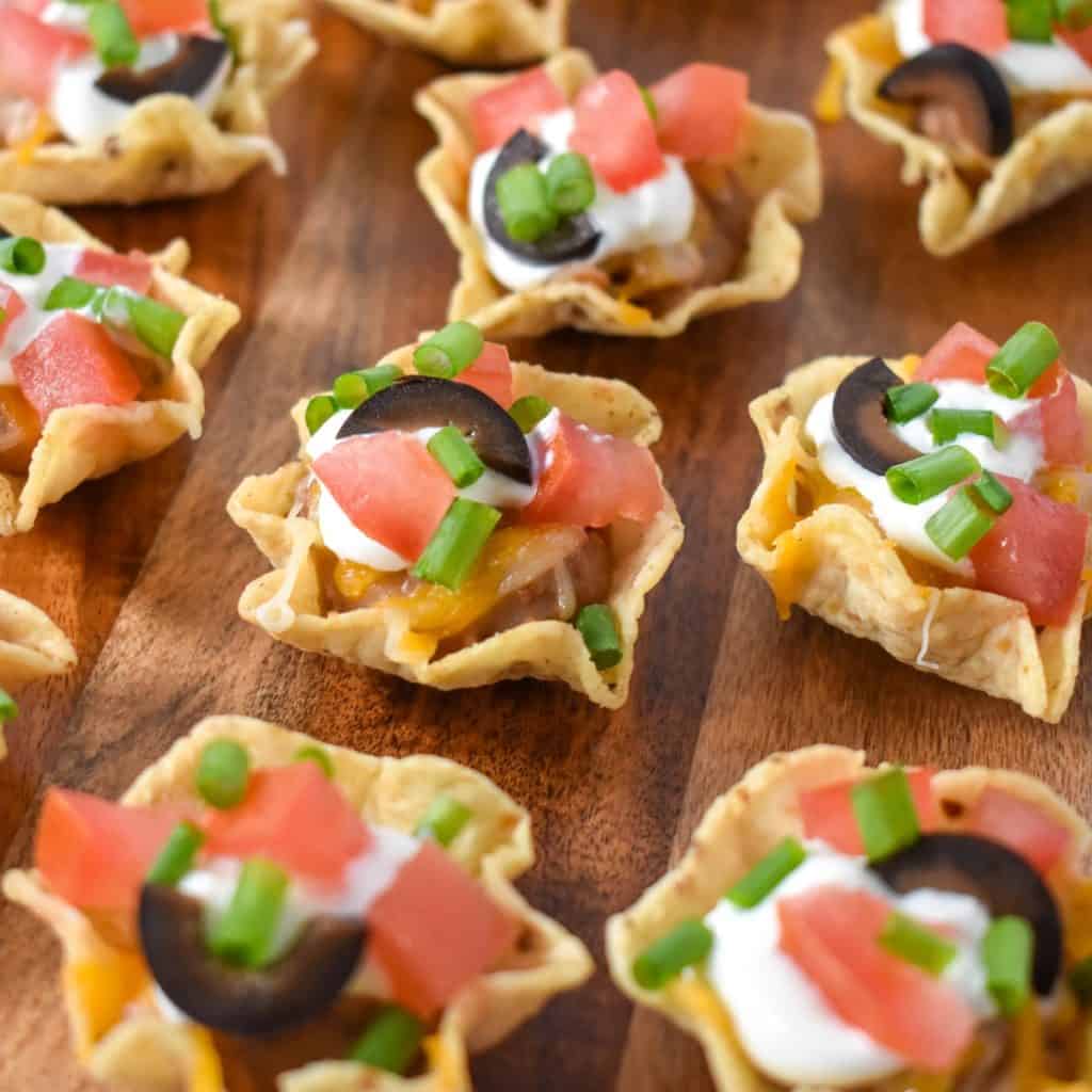 A close-up image of the mini taco bites arranged on a wood board.