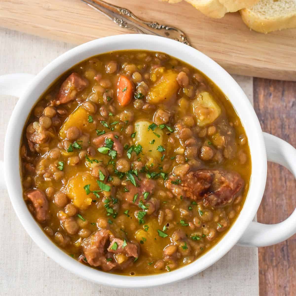 The potaje de lentejas (Cuban lentil soup) served in a white bowl.